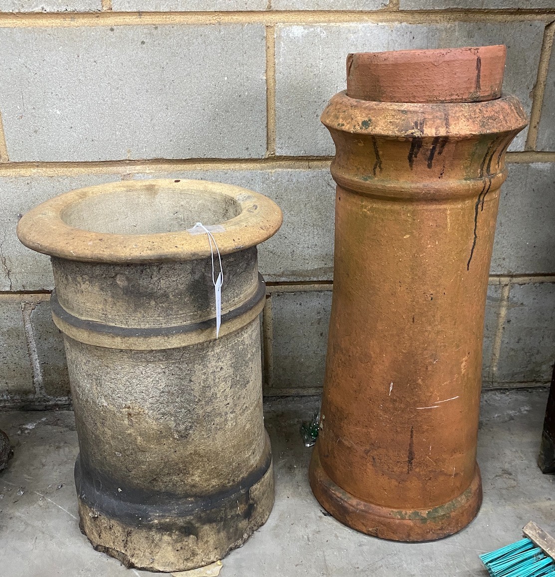 Two terracotta chimney pot planters, one with liner, largest height 62cm